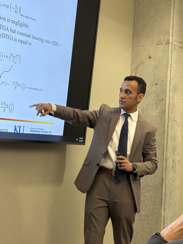 person points at screen with text