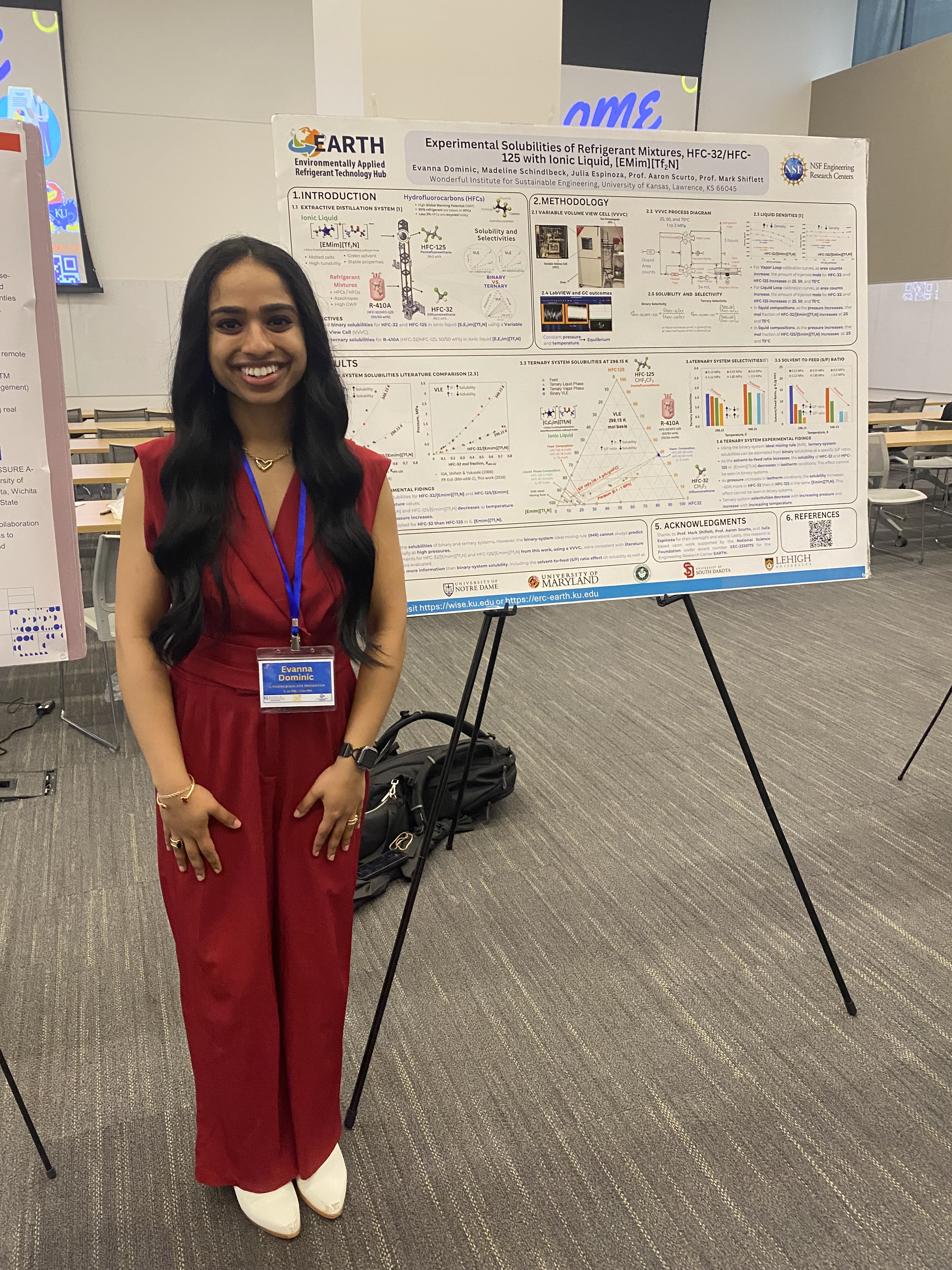person stands next to research poster